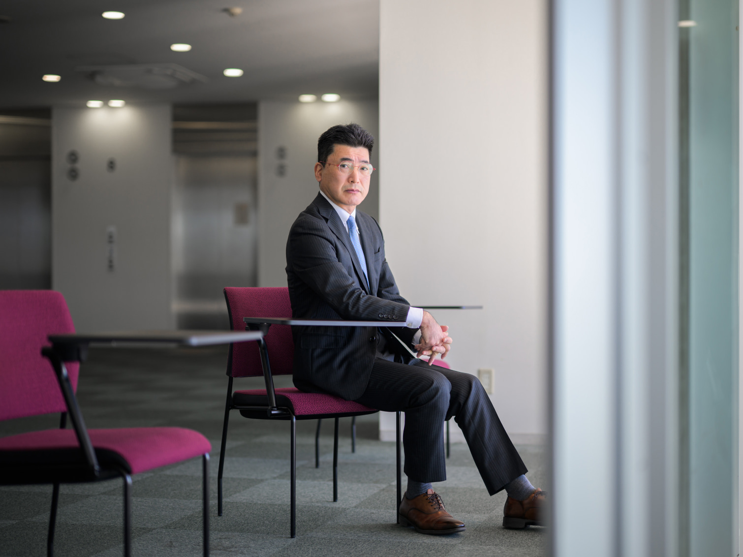 キャンパス内で腰掛ける塚本壮一先生