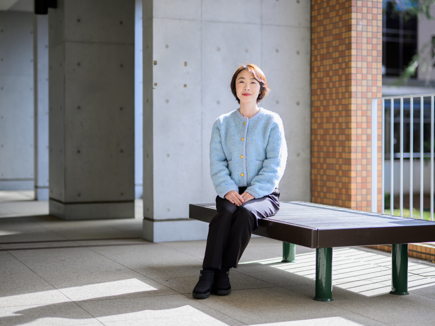 キャンパス内で腰掛ける髙橋弥生先生